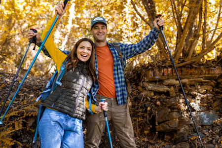 Couple celebrating that they finished their routte of hiking in the woods.の写真素材