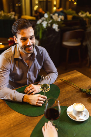 Couple on a romantic date in a restaurant. They drink wine.の写真素材