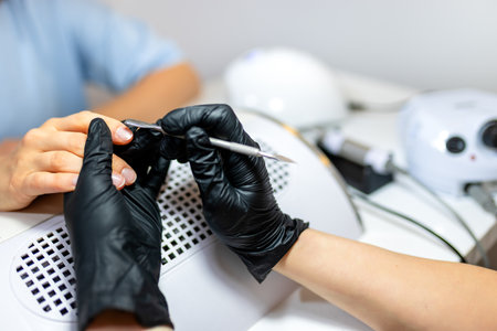 Manicurist trims cuticles in a beauty salon.の写真素材