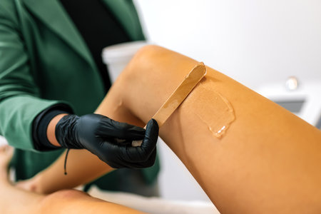 Beautician putting gel on clients leg for the laser hair removal.の写真素材