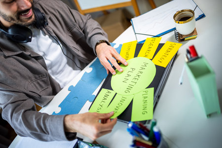 Man selecting marketing plan cards with key terms.の写真素材