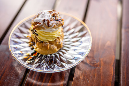 A plate of cream-filled profiteroles elegantly served on the terrace table