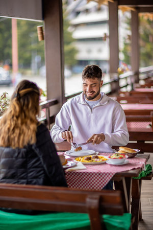 oung couple dining outdoors in the mountainsの写真素材