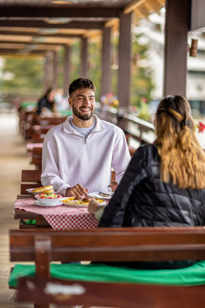 oung couple dining outdoors in the mountainsの写真素材