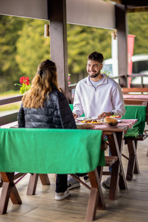 oung couple dining outdoors in the mountainsの写真素材