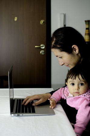 Mother using Laptop with her Daughter, Italyの写真素材