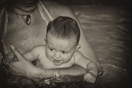 Mother and Daughter Enjoying the Swimming Pool, Italyの写真素材