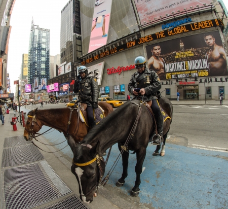 NEW YORK, USA - MAR 6: Police officers ride their horses downtown in New York on the main street, Manhattan on March 6th, 2011 in New York, USAのeditorial素材