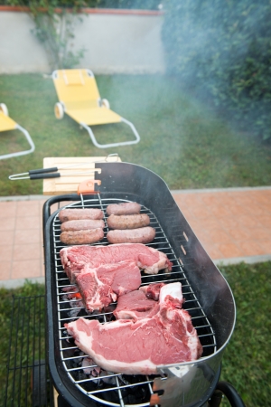 Cooking meat in the barbecue. Overhead view - Italyの写真素材
