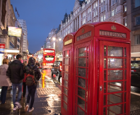 Red Telephone Booth in London on a crowded street at night - UKのeditorial素材