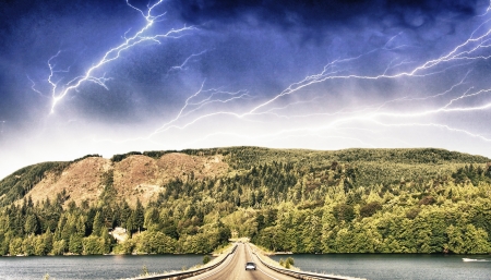 Beautiful road on the lake with storm colors.