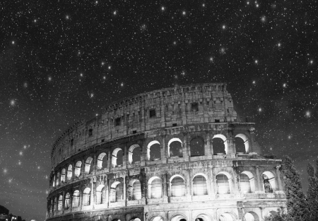 Colosseum - Rome. Night view with surrounding grass and park.