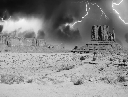 Massive sandstone pillars soar above iconic Monument Valley at sunset - USA