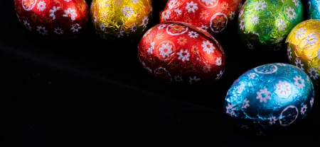 Beautiful colorful tiny Easter Eggs on black background の写真素材