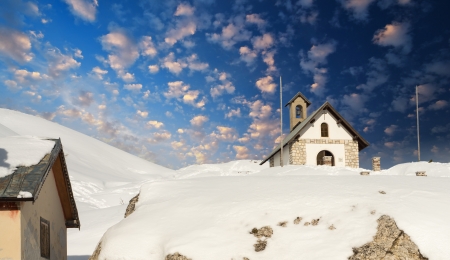 Small Church on Italian Alps in Winter, Beautiful sky colors.の写真素材