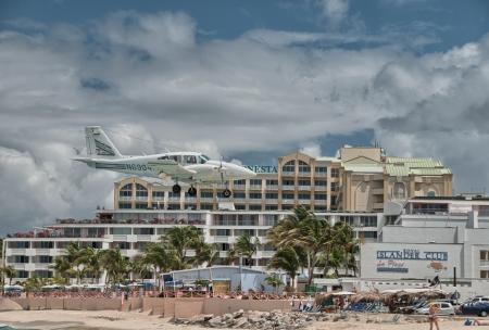 PRINCESS JULIANA AIRPORT, ST MAARTEN - APRIL 19: Airplane lands over Maho beach on April 19, 2010. The 2300m runway is approached over the seaのeditorial素材