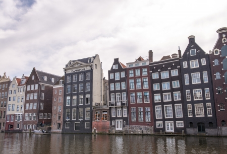Channels and historic buildings in Amsterdam. Typical Amsterdam architecture on a spring sunny day.のeditorial素材