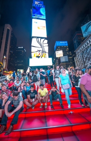 NEW YORK CITY - JUN 14: People relaxin the night on the red stairs of Duffy Square, June 14, 2013 in New York City. The recent transformation of the square allows for increased pedestrian trafficのeditorial素材
