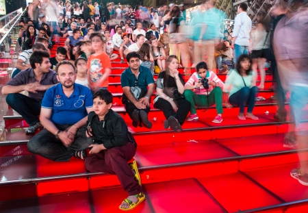 NEW YORK CITY - JUN 14: People relaxin the night on the red stairs of Duffy Square, June 14, 2013 in New York City. The recent transformation of the square allows for increased pedestrian trafficのeditorial素材