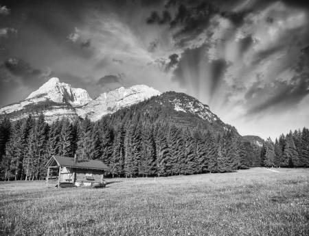 Alpin Hut with meadows, trees and mountain peaks - Summer colors at sunset.の写真素材