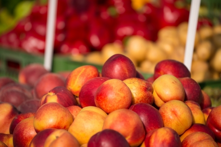 Fresh peaches on a wooden bucket.の写真素材