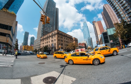 NEW YORK CITY -  JUN 14: Yellow taxi speeds up in Manhattan streets, June 14, 2013 in New York City.  Yellow cars serve as taxis in NYC and are easy to spot among other vehicles because of their colorのeditorial素材