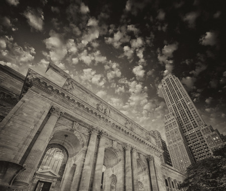 The New York Public Library. Side view with surrounding buildings and dramatic sky.の写真素材
