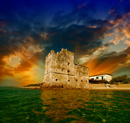 Ancient Tower over the Ocean at sunset.