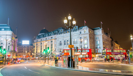 LONDON - SEP 17, 2013: Traffic and Double Decker Buses in Piccadilly Circus at night. Piccadilly Circus is a famous public space in London's West End, it was built in 1819.のeditorial素材