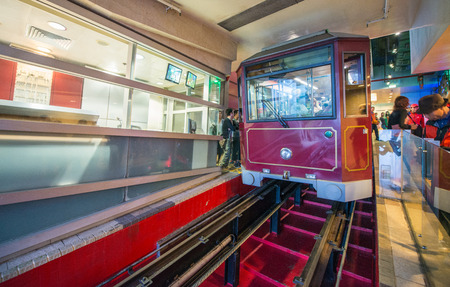 HONG KONG - APR 22, 2014: Peak Train takes passengers to Victoria Peak for city aerial view. More than 40 million people visit the city every year .のeditorial素材