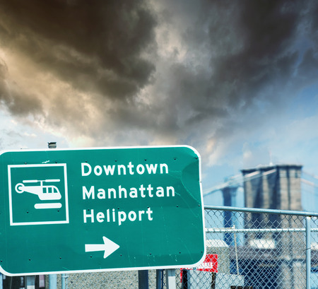 Heliport sign in Downtown Manhattan with Brooklyn Bridge on background.の写真素材