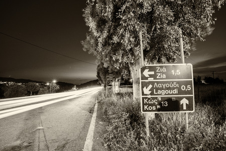 Road directions in Kos with car light trails, Greece.の写真素材