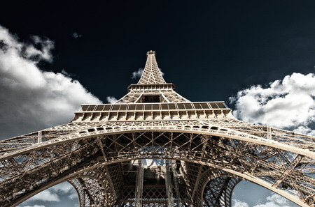 Paris. Powerful structure of Magnificent Eiffel Tower at sunset.