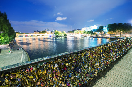 PARIS - JUNE 22, 2014: Love padlocks at Pont de l'Archeveche in Paris. The thousands of locks of loving couples symbolize love foreverのeditorial素材
