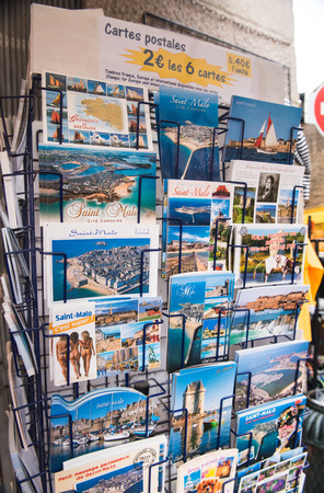 SAINT MALO, FRANCE - JUNE 13, 2014: Postcards on a city street shop. 8 million people visit the famous town in Brittany every year.のeditorial素材