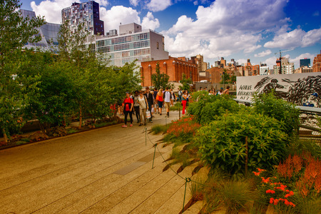 NEW YORK - JUNE 15, 2013: The High Line Park in New York with locals and tourists. The High Line is a popular linear park built on the elevated train tracks above Tenth Ave in New York Cityのeditorial素材