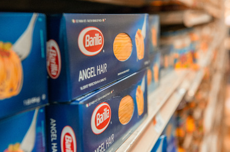 NEW YORK CITY - JUNE 8, 2013: Angel Hair box of Pasta Barilla on a supermarket shelf. The Barilla group produces several kinds of pasta and it is the world's leading pasta makerのeditorial素材