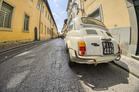 PISA, ITALY - APRIL 14, 2014: Old cinquecento parked in a narrow city street. The Fiat 500 Cinquecento is a city car produced by the Italian manufacturer Fiat between 1957 and 1975.のeditorial素材