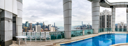 HONG KONG - MAY 12, 2014: Stunning panoramic view of Hong Kong Island and Kowloon on a cloudy day from tower roof. Last year HK hosted more than 54 million visitors, most of them from the mainland.のeditorial素材