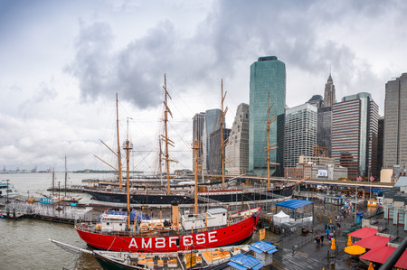 NEW YORK CITY - JUNE 10, 2013: South Street Seaport and Pier 17 in Lower Manhattan. The area includes modern tourist malls featuring food, shopping and nightlife, with a view of the Brooklyn Bridge.のeditorial素材