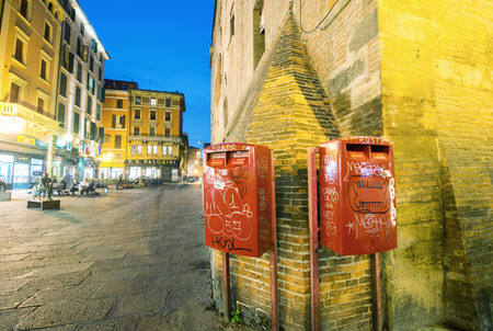 BOLOGNA, ITALY - OCTOBER 9, 2014: Red mail boxes outside a post office in Bologna at nightのeditorial素材