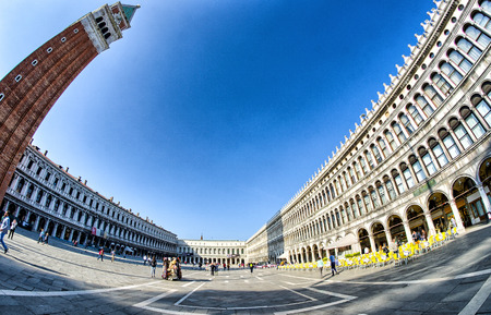 VENICE - APRIL 7, 2014: Tourists enjoy Saint Mark Square on a beautiful spring day. Venice is visted by more than 20 million people every year.のeditorial素材