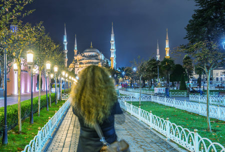 ISTANBUL - SEPTEMBER 17, 2014: Tourist enjoy night view of Blue Mosque. Istanbul is visited by more than 11 million people every year.のeditorial素材