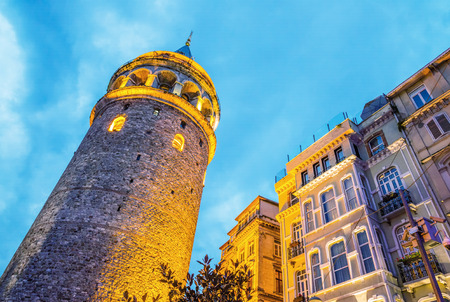 Beautiful sunset view of Galata Tower framed by street buildings, Istanbul.のeditorial素材