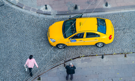 Istanbul. Taxi on a narrow ancient city street with people walking, aerial view.の写真素材