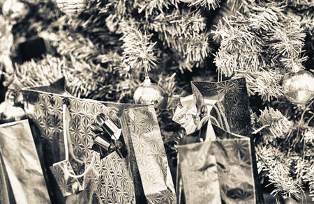 Colourful Christmas gift bags under the tree. Holiday concept.の写真素材