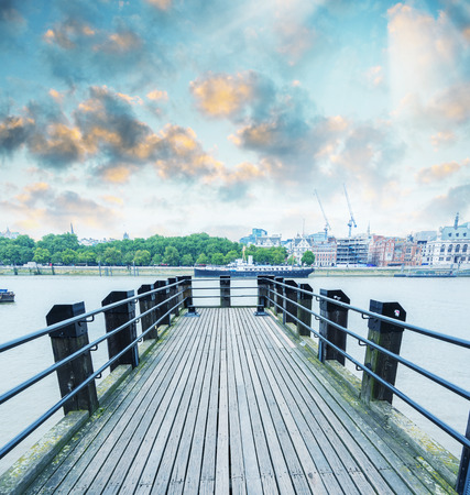 Wooden fishing pier on the south bank of the river Thames in London.の写真素材