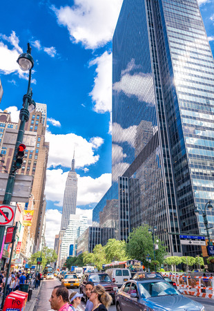 NEW YORK CITY - JUNE 14, 2013: Tourists walk along city streets on a beautiful sunny day. More than 50 million people visit New York every year.のeditorial素材