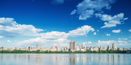 Manhattan buildings over Central Park Lake, New York City.の写真素材