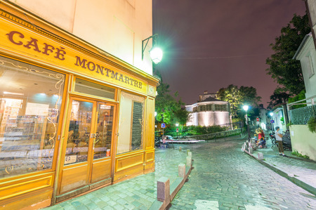 PARIS, FRANCE - JUNE 20, 2014: Tourists enjoy Montmartre city life on a beautiful night. More than 30 million people visit Paris every year.のeditorial素材